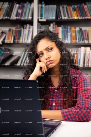 Thinking, sitting on chair, library, laptop, working on laptop, books, student, confused girl