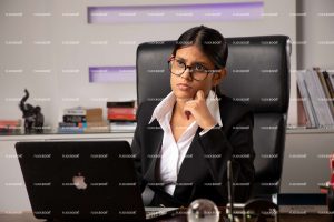 sitting on chair, office, professional, girl, laptop, working on laptop, full suite, black suite, business, specs girl, girls, thinking, sitting in office, , meeting, business lady