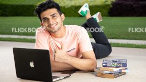 
									Emotions , a boy , laying down , casual outfit , thinking ,  posing , laptop , books , legs crossed , working , studying , looking at laptop , smiling , happy , thumbs up 