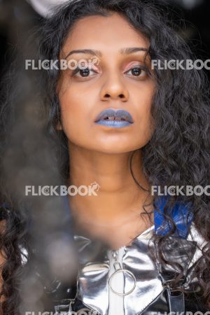 
									Fashion Design, A girl with blue lipstick , dark girl , curly hair , staring , posing , upward eyebrows , straight nose , facial expressions , fashionable outfit , 