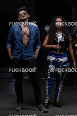 
									Fashion Design, a couple pic , A girl with blue lipstick , dark girl , curly hair , staring , posing , upward eyebrows , straight nose , facial expressions , dark skin , confident , standing , fashionable outfit , wearing a jean jacket , casual outfit , wearing sunglass , 