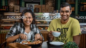 
									Food , a couple , having a breakfast meal  , smiling , happy , at a cafeteria , having a glass of coffee / tea