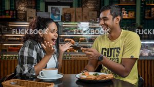 Food , a couple , having a breakfast meal , smiling , happy , at a cafeteria , having a glass of coffee / tea