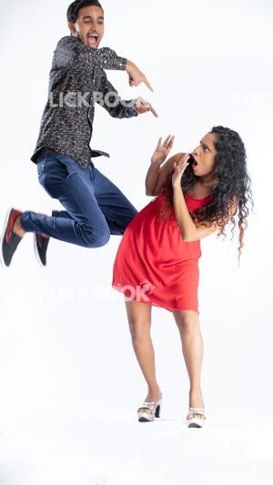 Entertainment , a couple , guy jumping , pointing the girl , girl scared , afraid , casual outfit , enjoying