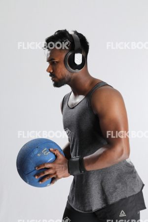 Man Wearing Headphones, Holding Mini Pilates Ball, Mini Exercise Ball, Getting Ready to Throw Ball, Strong Guy
