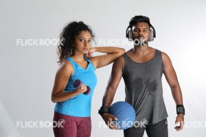 
									Fitness , a couple , sporty , guy holding ball ,  girl’s elbow on guy’s shoulder , tired , sweaty , girl holding a dummbbell 