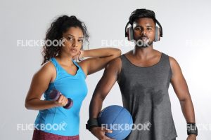 
									Fitness , a couple , sporty , guy holding ball ,  girl’s elbow on guy’s shoulder , tired , sweaty , girl holding a dummbbell 