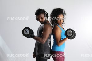 Fitness , a couple , sporty , both holding dummbbells , tired , sweaty 