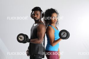 
									Fitness , a couple , sporty , both holding dummbbells , tired , sweaty , staring