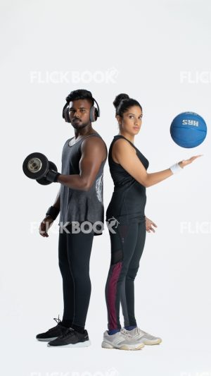 
									Fitness , a couple , sporty , guy holding dummbbells , tired , sweaty , staring , girl holding a ball