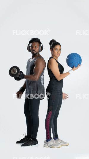 Fitness , a couple , sporty , guy holding dummbbells , tired , sweaty , staring , girl holding a ball