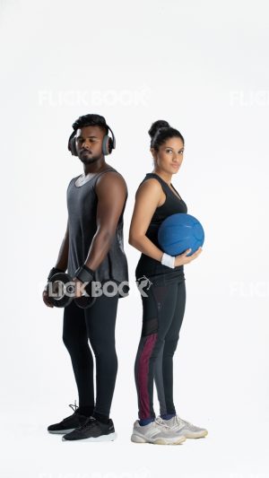
									Fitness , a couple , sporty , guy holding dummbbells , tired , sweaty , staring , girl holding a ball