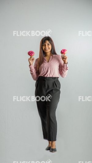 Food , A girl , holding two donuts from her fingers , smiling , office wear , standing 