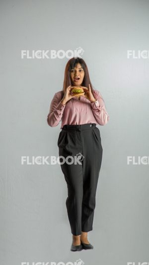 
									Food , A girl , holding a burger , smiling , office wear , standing , staring , posing ,