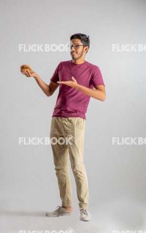 
									Food , A boy , holding a burger , smiling , casual outfit  , standing , staring , posing , smiling , showing the burger 