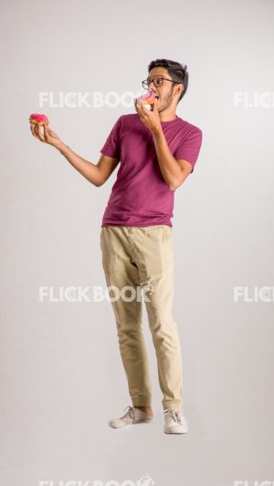 
									Food , A boy , holding a donut  , smiling , casual outfit  , standing , staring , posing , eating a donut 