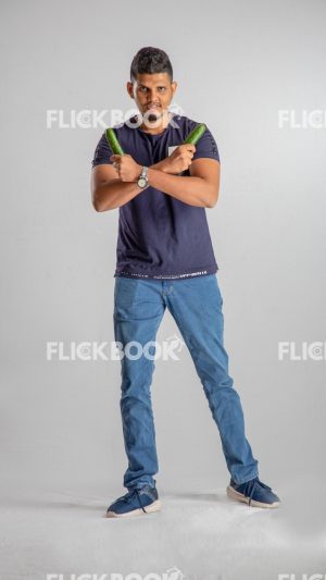 Food , A boy , holding two cucumbers , smiling , casual outfit  , standing , staring , posing , 