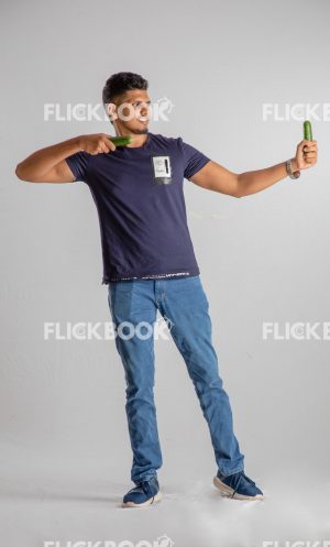 
									Food , A boy , holding two cucumbers , smiling , casual outfit  , standing , staring , posing , 