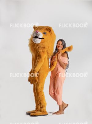 Entertainment , lion costume , brown , a girl standing , laughing , brown  , standing , enjoying , playing with tail 