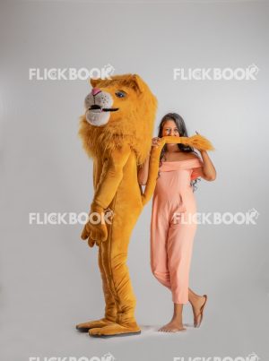 Entertainment , lion costume , brown , a girl standing , laughing , brown  , standing , enjoying , playing with tail 