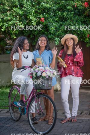 
									Entertainment, Three girls with a flower bicycle , at a garden , wearing a hat , casual outfit , smiling , happy , laughing  , waving hands 