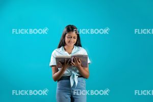 Talents , girl, reading a book  , smiling , enjoying , concentrating , standing 