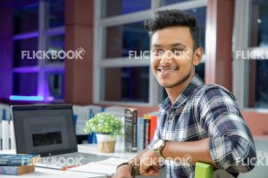 
									Library , working , laptop , book , staring , smiling , casual outfit , sitting , happy , boy
