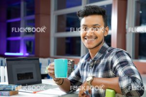 
									Library , working , laptop , book , staring , smiling , casual outfit , sitting , happy , boy , holding a cup