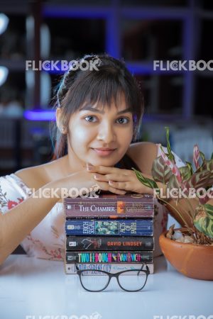 
									Library , books , smiling , casual outfit , sitting , happy , girl , chin on books 
