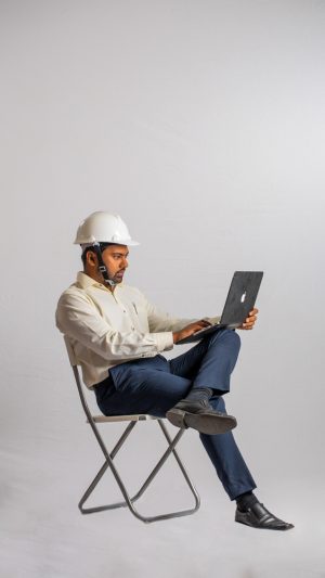 Occupations , contractor, busy , formal outfit , guy , sitting , working , laptop 