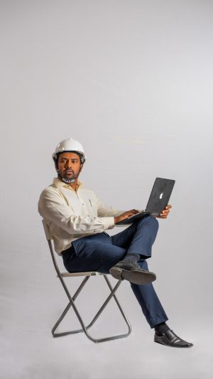 Occupations , contractor, busy , formal outfit , guy , sitting , working , laptop 