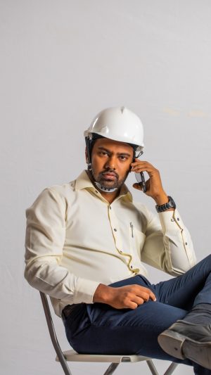 Occupations , contractor, busy ,  formal outfit , guy ,  sitting , on a call , mobile phone 