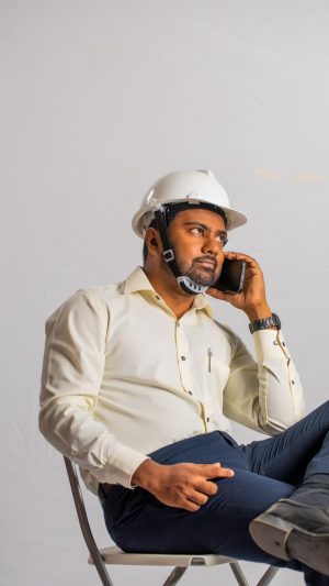 Occupations , contractor, busy ,  formal outfit , guy ,  sitting , on a call , mobile phone 