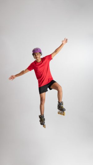 Sports , wheel shoes , stunting , roller shoes , wearing a helmet , posing , playing , roller skates 